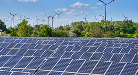 Large solar park with wind turbines at the horizon. elxeneize - stock.adobe.com